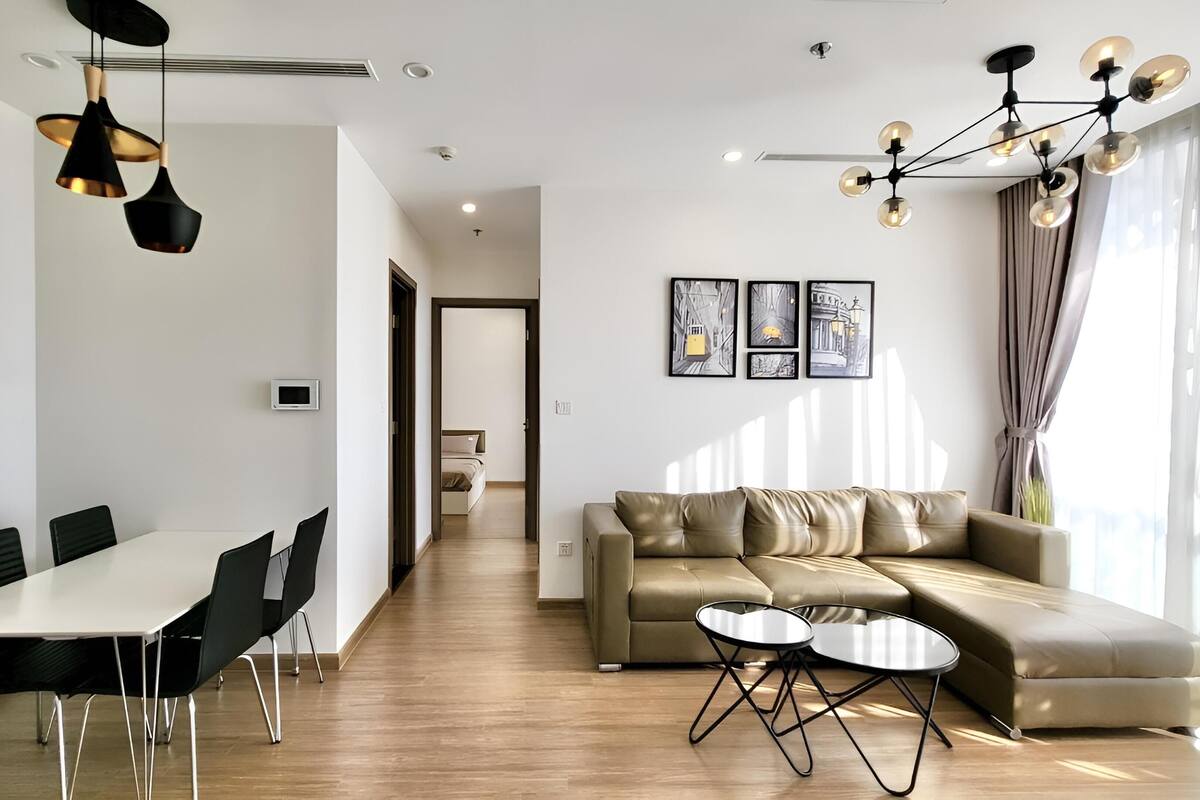 A modern living room with a dining area, a sofa, and a coffee table.