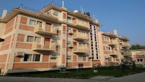 A multi-story residential building with balconies, a flat roof, and a brick facade. - MeroStay 259 KB Resort (Purano Jhangajholi)