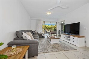 Relax in this stylish living room with a comfortable sofa, coffee table, and flat-screen TV.