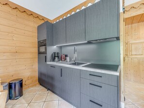 A modern kitchen with grey cabinets, a stainless steel sink, and a built-in oven. - Champagny-en-Vanoise, 2R, 46m², 4 Pers, Terrace, WIFI, Hotel Services Included (Champagny-en-Vanoise)