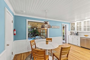 Enjoy meals at the round dining table surrounded by comfortable chairs.
