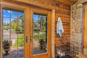 Step outside through the large glass door to an outdoor space.