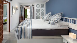 A bedroom with a bed, bedside table, and a view of the outside. - Holiday Home 'Dalias' with Sea View, Wi-Fi and Air Conditioning (Nerja)