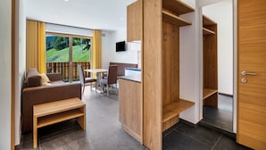 Une pièce moderne comprenant un banc en bois, un canapé, une table à manger et des chaises.