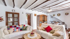 A cozy living room with two white sofas, a wooden coffee table, and a wooden cabinet. - Holiday Home "Casa Rural Atalaya-Coy" with Mountain Views, Private Terrace and Garden (Coy)