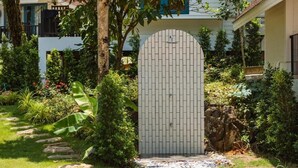 A gated entrance with a paved pathway leading to a building. - Sea Escape Koh Chang (Ko Chang)