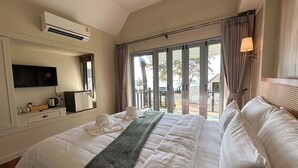 A hotel room with a bed, a flat-screen TV, a minibar, and a view of the outdoors. - Sea Escape Koh Chang (Ko Chang)