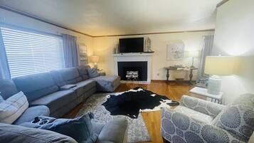 Smart TV, fireplace, books, computer monitors