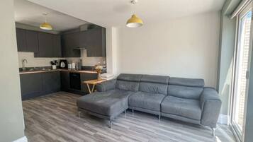 Basic Apartment, Multiple Beds | Living area | TV