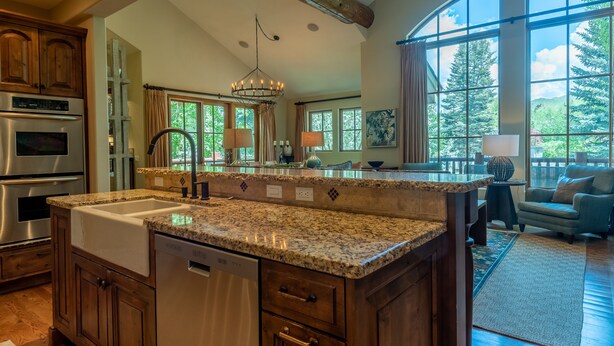 A spacious kitchen with granite countertops, stainless steel appliances, and a large island.