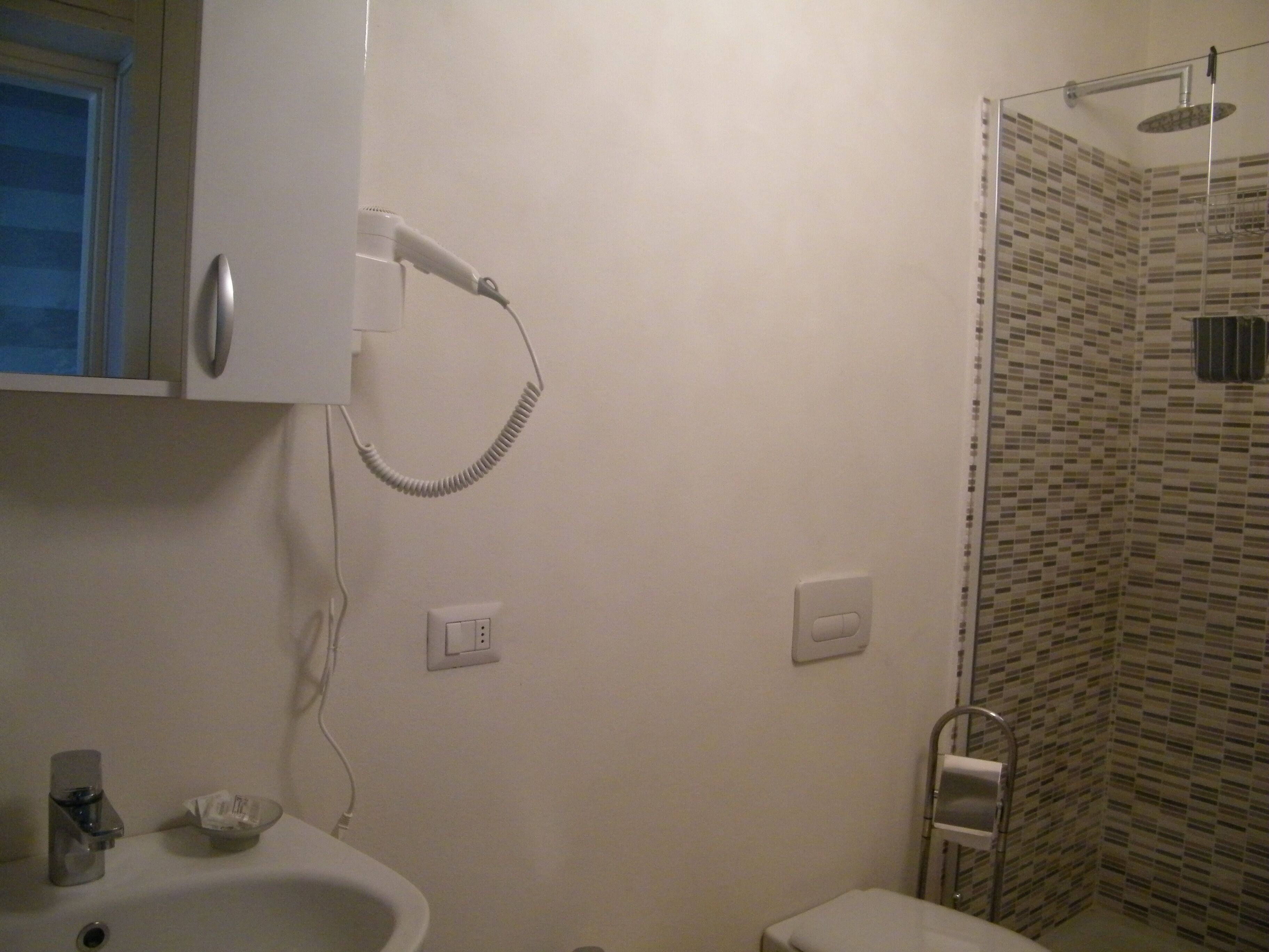 Une salle de bain avec une douche, un lavabo et des toilettes.
