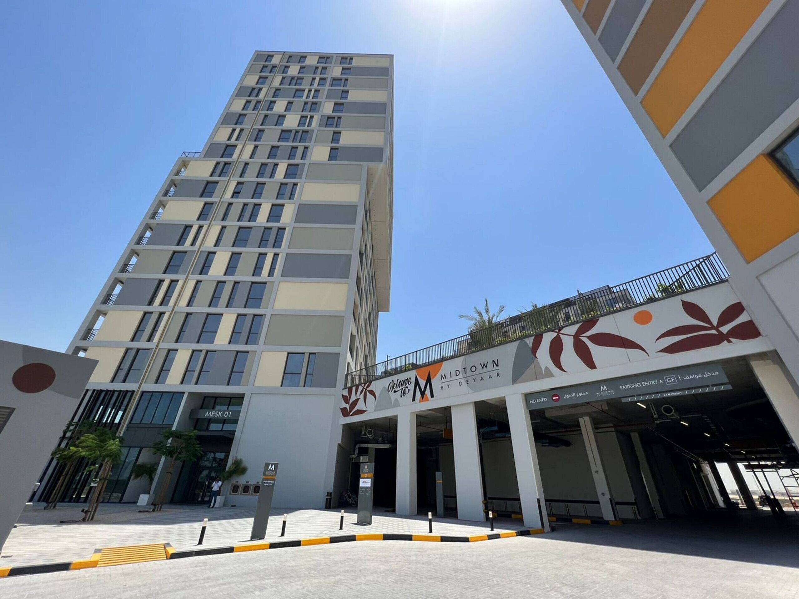 A modern building with a prominent entrance labeled 'Midtown by DeYaar.'