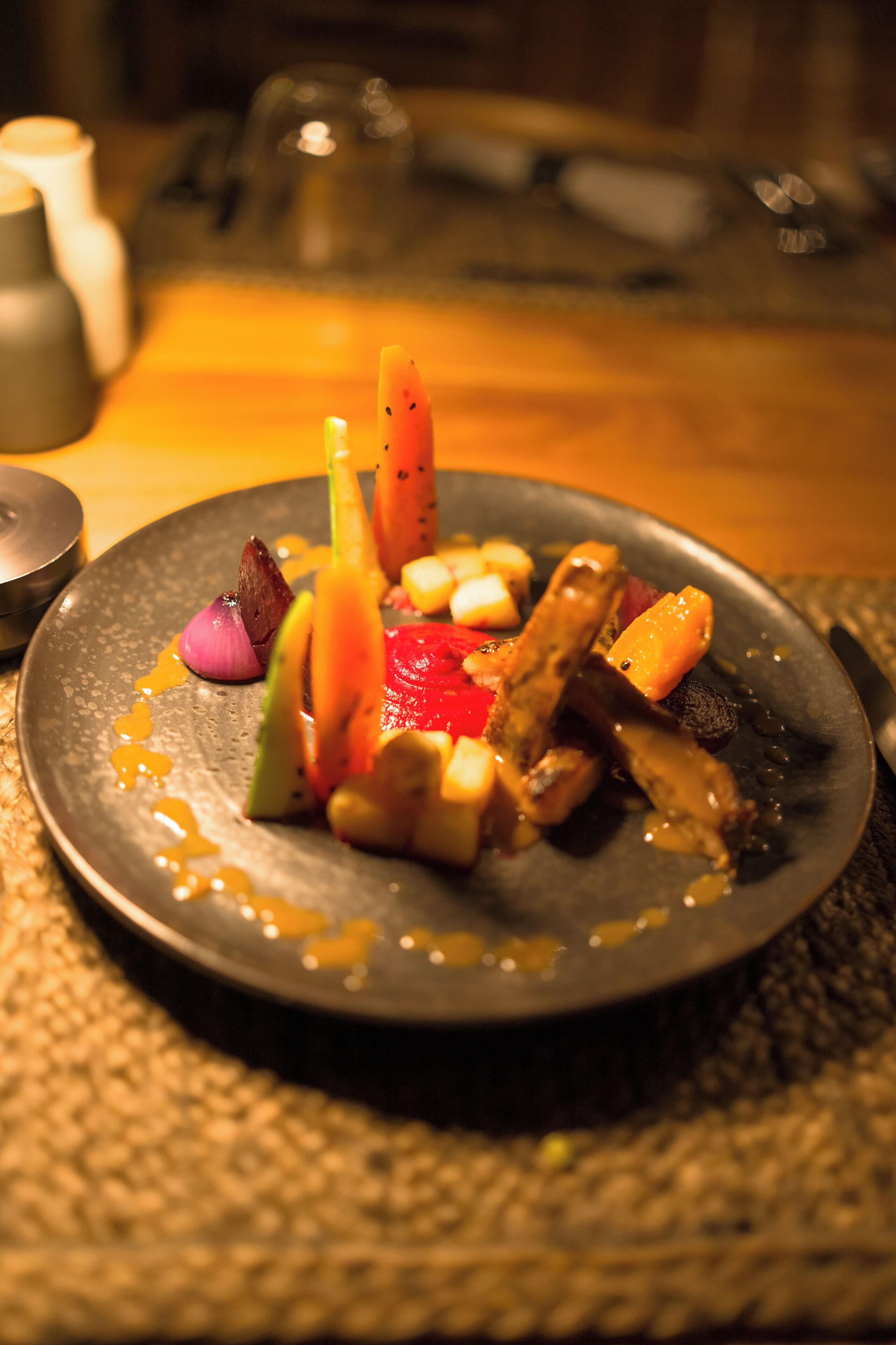 A plate of food with various vegetables and a sauce.