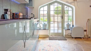 A modern kitchen with a glass bar, a large window, and a deer antler decoration. - Chichester Lodge -  a cottage that sleeps 8 guests  in 4 bedrooms (Chichester)