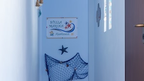 A sign reading "Stella Marina Apartment" with nautical decorations. - Stella Marina apartment, vacation home in Trapani, a few steps from the sea  (Trapani)