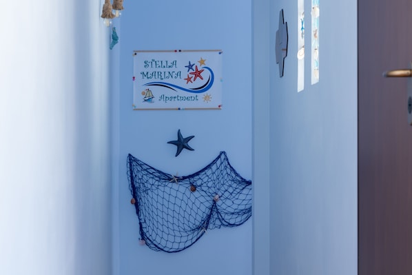 A sign reading "Stella Marina Apartment" with nautical decorations. - Stella Marina apartment, vacation home in Trapani, a few steps from the sea (Trapani)