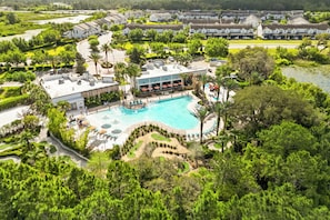 A resort with a swimming pool, lounge area, and golf course. - Awesome three bedroom townhome near Disney 322 (Davenport)