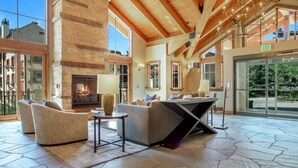 Un vestíbulo amplio con chimenea, asientos cómodos y vistas al exterior.
