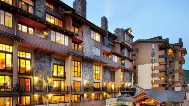 A multi-story hotel with stone facades, balconies, and a landscaped courtyard. - Vail - Lionshead Condominiums 2 Bedroom Condo (Vail)