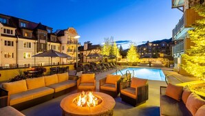 A poolside area with outdoor seating, a fire pit, and a pool. - Vail - Lionshead Condominiums 2 Bedroom Condo (Vail)
