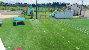 A playground with a soccer field, a small building, and a tennis table. - Villa Kate Zadarvillas (Nin)