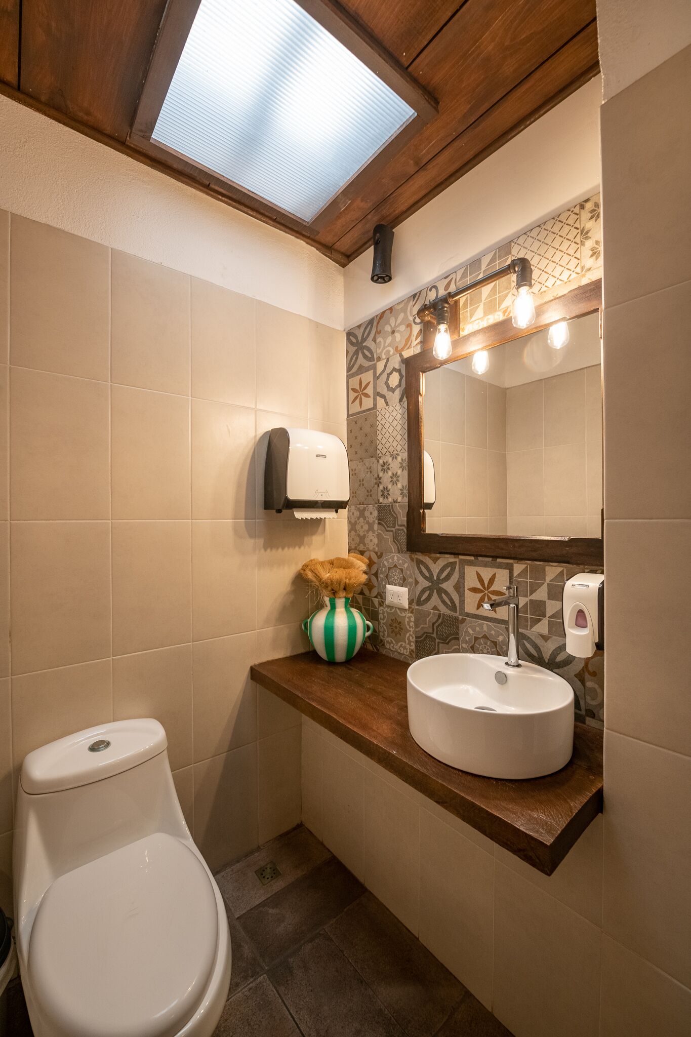 Un baño con inodoro, lavabo y espejo.