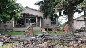 A two-story house with a porch, a large tree, and a fallen wooden fence. - Cozy country farmhouse (Prairie City)