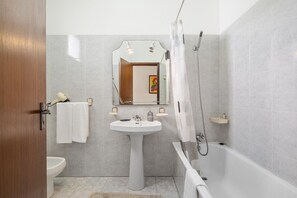 Bathtub, hair dryer, towels
