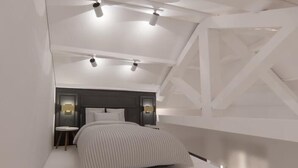 A modern bedroom with a sloped ceiling, a bed with a striped bedspread, two bedside tables with lamps, and a dark headboard. - CorsoVittorio87Suite (Cagliari)