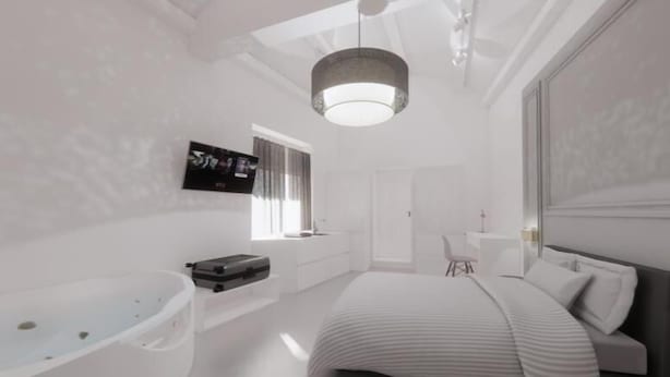 A modern bedroom with a large bed, a built-in bathtub, and a television on the wall. - CorsoVittorio87Suite (Cagliari)
