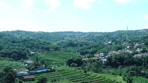 A rural landscape with terraced fields and scattered houses. - Best Choice 2Br Apartment At Taman Melati Jatinangor (Hegarmanah)