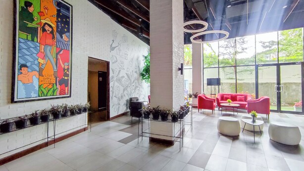 A spacious lobby with a large mural, modern seating, and potted plants. - Comfy And Modern Studio At Cordova Edupartment Semarang Apartment (Semarang)