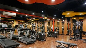 A gym with treadmills, elliptical machines, and weightlifting equipment. - Minimalist Studio Apartment Signature Park Grande (Jakarta)