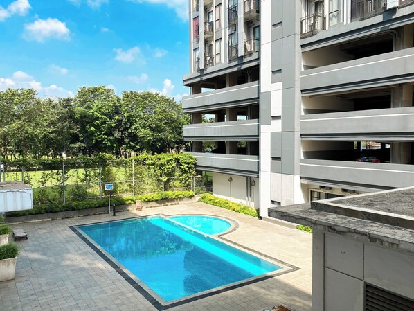 Outdoor pool - Cozy Stay Studio (No Kitchen) Elvis Tower Apartment (Cikarang)