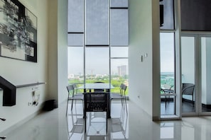 Enjoy a city view from the large window, with a glass table and comfortable seating for four.