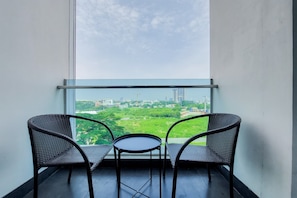 Relax on the balcony with a view of the park and distant buildings.