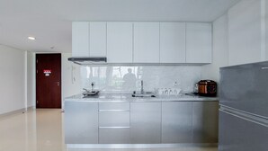 A modern kitchen with stainless steel appliances, a built-in oven, and a microwave.
