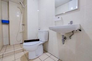 A bathroom with a toilet, a sink, and a shower.