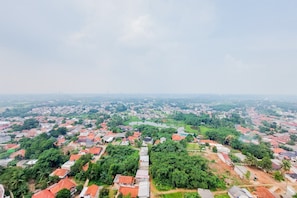 An aerial view of a residential area with houses, greenery, and a river. - Best Deal And Comfortable 2Br Serpong Garden Apartment (Cisauk)