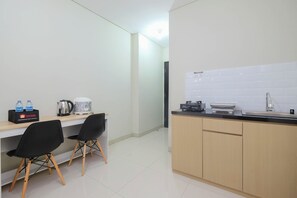 Enjoy a compact kitchenette with sink, coffee maker, and seating for two.