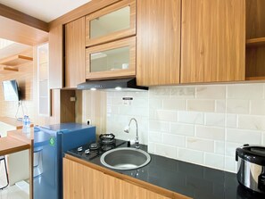 Deluxe Apartment | Private kitchen | Full-size fridge, stovetop, rice cooker, cookware/dishes/utensils - Cozy Stay Studio At Tamansari Mahogany Karawang Apartment (Karawang)