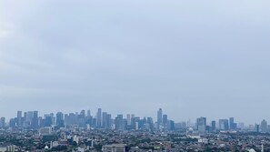 A cityscape with a dense cluster of high-rise buildings and a mix of residential areas. - Brand New And Comfort Studio At Vasaka Solterra Apartment (Jakarta)