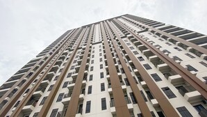 A high-rise building with multiple floors, featuring a modern architectural design with a series of balconies and windows. - Brand New And Comfort Studio At Vasaka Solterra Apartment (Jakarta)
