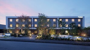 A modern hotel building with a flat roof, multiple windows, and a sign indicating it is a Fairfield by Marriott.