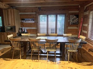 Enjoy meals in this cabin's dining area, featuring a large table and comfortable seating for six.