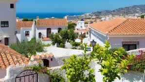 A coastal town with white buildings and terracotta roofs, overlooking the sea. - Cecilie by Interhome (Nerja)