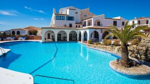 A large swimming pool surrounded by a white building with multiple arches and balconies. - Cecilie by Interhome (Nerja)