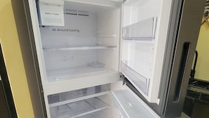 An open refrigerator with multiple shelves and a freezer compartment. - FIESTA MIRAMAR (Ciudad Madero)
