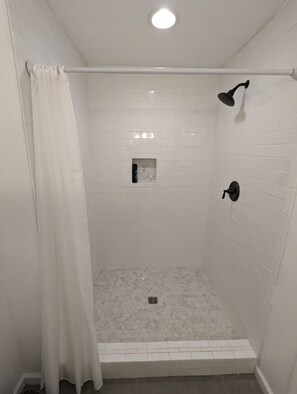 Shower, hair dryer, towels, toilet paper