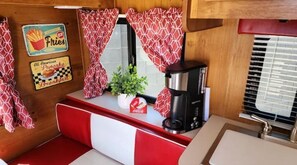 Enjoy cooking in this compact kitchen with a coffee maker and a convenient breakfast sign.